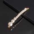 Detail of elegant gold hairpin featuring a gradient row of white imitation pearls - Gourd Shaped Curved Bobby Pin