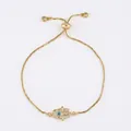 Detailed close-up of gold Hamsa hand bracelet with white pavé stones and blue evil eye charm - brb66-B Blue Eye Hamsa Hand