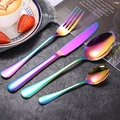 Rainbow stainless steel cutlery set with dinner fork, knife and spoons on a dark table - Rainbow 4-Piece Set