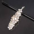 Minimalist cream pearl hair clip with silver base and bow design on black mirror surface - Large 3-Flower Silver Bobby Pin