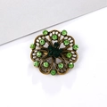 Vintage bronze flower brooch with sparkling green rhinestones on a white background - Hollow Flower - Green Rhinestone (XD5477-4)