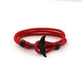 Detailed view of red woven cord bracelet with a black whale tail pendant fastener - Black Whale Tail Buckle / Red