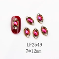 Detail of vintage ruby nail charms with antique gold frames and rhinestone accents - 2549 AB Red