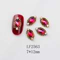 Macro detail of retro oval red gemstone nail charms with gold frame in 7x12mm size - 2563 AB Red