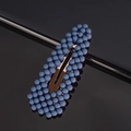 Detail of dark blue pearl hair clip with gold metal BB clip on reflective surface - Ink Blue Waterdrop