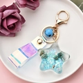 Detail of blue starfish keychain with sequins and holographic laser strap on plate - Blue Starfish