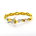Close-up of woven polyester rope bracelet featuring a silver metal airplane charm - Yellow Black Orange Camo
