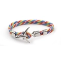 Close-up of rainbow woven rope bracelet with polished silver airplane charm detail - Rainbow