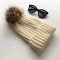 Cream knit beanie featuring a large fluffy brown faux fur pom pom and stylish sunglasses - Beige