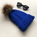 Royal blue knit beanie with a large brown faux fur pom pom and stylish black sunglasses - Royal Blue