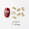 Détail macro de nœuds dorés pour nail art avec strass, dimensions de 7,3x5mm environ - Nœud Doré Strass AB (LF2574)