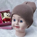 Toddler knitted beanie in dusty pink ribbed fabric on a white fur display - Adjustable / Khaki
