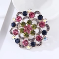 Macro detail of luxury floral gemstone brooch with colorful crystals and gold-tone base - Radioactive Colorful Flower