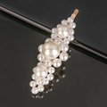 Close-up of elegant gold metal hair clip with white artificial pearls on black background - Large Three Flowers Gold
