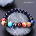 Macro shot of solar system bracelet with 8mm and 10mm natural stone beads on dark rock - Planet Bracelet (10+8mm Beads/Scene Style)