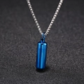 Detailed view of a blue metal capsule pendant on a silver steel chain over a dark background - Blue (Chain Length 60cm)