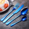 Blue stainless steel cutlery set with knife fork and spoons on a dark stone background - Blue 4-Piece Set