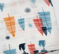 Folded cotton muslin baby swaddle blanket with orange and blue feather and star patterns - Forest Fox