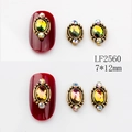 Close-up of LF2560 7x12mm vintage oval nail art charms with colorful rhinestones - 2560 Iridescent Green