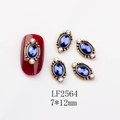 Macro view of blue gemstone nail art charm with 7x12mm vintage gold frame detailing - 2564 Royal Blue