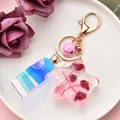 Close-up of star resin keychain with pink sequins, dried flowers, and holographic strap - Pink Starfish