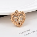 Primer plano de colgante de corazón en latón dorado con flor de lis y círculos calados - Corazón Fleur-De-Lis (KK34) / Oro rosa