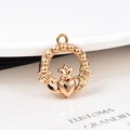 Detailed macro view of rose gold Claddagh heart pendant with crown on white background - Claddagh (KK36) / Rose Gold
