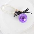 Preserved purple rose keychain with pearl beads and a black ribbon in a clear orb - Violet