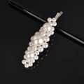 Detailed view of large and small pearls woven on a fishline bobby pin over black surface - Silver Large 3 Flowers Pearl Clip