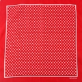 Flat lay of a red cotton bandana with white polka dots and 100% cotton print text - Red Small Dots