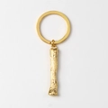 Detailed view of golden metal keychain with textured branch pendant and round ring - Letter I