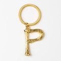 Close-up of golden letter P keychain with bamboo texture finish on white background - Letter P