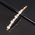 Macro view of gold alloy hairpin featuring alternating pearls on a sleek black background - Mixed Size Pearl Clip