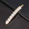 Close-up of golden alloy hair clip with white faux pearls and polished reflective surface - 8-Small Flowers Curved Bobby Pin