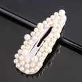 Elegant BB hair clip featuring white pearls on a sleek black reflective surface - All White Pearl
