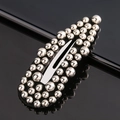 Detailed close-up of oval hair clip featuring dense silver metallic beads and metal base - All Silver Beads