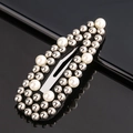 Macro shot of rectangular black hair clip with silver studs and white pearl accents - White & Silver Beads