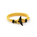 Adjustable yellow woven cord bracelet featuring a black whale tail anchor charm on white background - Black Whale Tail Buckle / Yellow