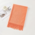 Soft orange faux cashmere scarf with fringe tassels laid flat on a clean white surface - Orange