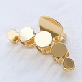 Golden geometric round alloy hair claw clip with a polished finish on white fabric - KC Gold