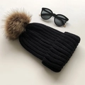 Winter chunky knit beanie in black featuring a fluffy brown faux fur pom pom - Black