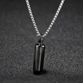Detailed close-up of a black capsule pendant on a silver steel chain over a dark background - Black (Chain Length 60cm)