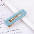 Detail view of light blue acetate hair clip with glitter finish and gold metal spring clip - Glitter Blue Square