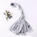 Close-up of a light grey cashmere scarf showing soft texture and premium fringe details - Light Gray