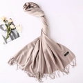 Detail of beige cashmere scarf with elegant fringe trim and high-quality fabric texture - Khaki