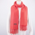 Close-up of red cashmere scarf with fringe details and a black material label - Orange Red