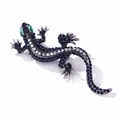 Detailed close-up of crystal lizard brooch with blue rhinestones and silver base - Black & White Lizard