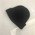 Detailed view of black knitted beanie showing classic ribbed texture and folded cuff edge - One Size (Elastic) / Black