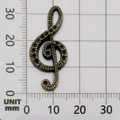 Antique bronze music note G-clef pendant on measurement grid showing 31mm height - G-Clef-7411