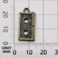 Bronze retro cassette tape metal charm pendant shown on a millimeter scale grid - Cassette Tape-48